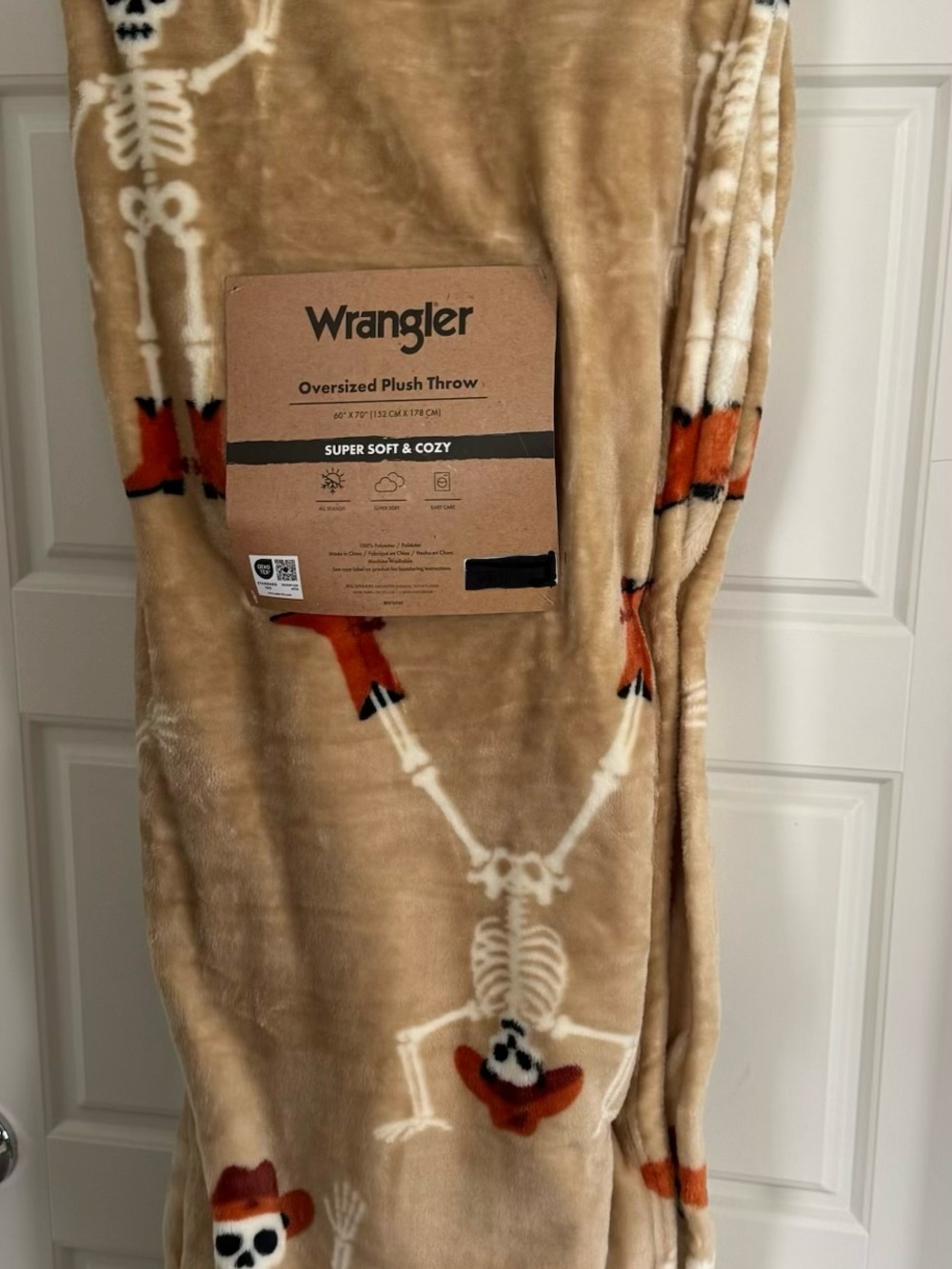 Wrangler Tan Plush Throw with White Skeletons and Orange Accents